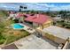 Aerial view of the property showcasing the sparkling pool, lush landscaping, and expansive driveway at 8880 W La Mancha Ave, Las Vegas, NV 89149