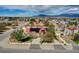 An aerial view showcasing a home with beautiful desert landscaping at 8880 W La Mancha Ave, Las Vegas, NV 89149