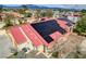 Aerial view of the home's red tile roof with solar panels and desert landscaping at 8880 W La Mancha Ave, Las Vegas, NV 89149