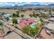 Aerial view showcases a home with a pool, desert landscaping, and mountain views at 8880 W La Mancha Ave, Las Vegas, NV 89149