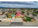Aerial view highlighting the house, the large driveway, and mountain views in the background at 8880 W La Mancha Ave, Las Vegas, NV 89149
