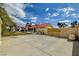 Private backyard with a pool, green lawn, and patio area, perfect for entertaining at 8880 W La Mancha Ave, Las Vegas, NV 89149
