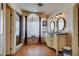 Bathroom featuring dual sinks, a tub, and a walk-in shower at 8880 W La Mancha Ave, Las Vegas, NV 89149