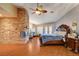 Spacious bedroom boasts a brick fireplace, French doors, and hardwood floors at 8880 W La Mancha Ave, Las Vegas, NV 89149