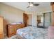 Bedroom with a ceiling fan, a dresser, and a mirrored closet at 8880 W La Mancha Ave, Las Vegas, NV 89149