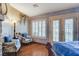This bedroom features two lounge chairs, a floor lamp, and French doors at 8880 W La Mancha Ave, Las Vegas, NV 89149