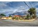 Single-story home featuring desert landscaping, a red tile roof, and solar panels at 8880 W La Mancha Ave, Las Vegas, NV 89149