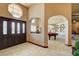 Elegant foyer featuring a grand entrance, arched doorways, and stylish tile flooring at 8880 W La Mancha Ave, Las Vegas, NV 89149