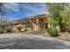 Stunning single-story home with desert landscaping, a red tile roof, and solar panels at 8880 W La Mancha Ave, Las Vegas, NV 89149