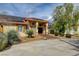 Stunning single-story home with desert landscaping, a red tile roof, and solar panels at 8880 W La Mancha Ave, Las Vegas, NV 89149