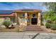 Inviting home featuring a terracotta roof, solar panels, and stone accents leading to the double-door entrance at 8880 W La Mancha Ave, Las Vegas, NV 89149