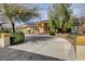 Beautiful single-story home with desert landscaping, a circular driveway, and mature trees at 8880 W La Mancha Ave, Las Vegas, NV 89149