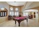 Game room with pool table, seating and octagon windows at 8880 W La Mancha Ave, Las Vegas, NV 89149