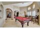 Well-lit game room with a pool table, and sitting area with chairs at 8880 W La Mancha Ave, Las Vegas, NV 89149