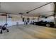 Spacious garage with storage cabinets, a service door, and room for multiple vehicles at 8880 W La Mancha Ave, Las Vegas, NV 89149
