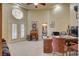 Open concept living room features high ceilings, ceiling fan and doorways to other rooms at 8880 W La Mancha Ave, Las Vegas, NV 89149