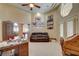 Spacious living room featuring high ceilings, a ceiling fan, sofa and natural light at 8880 W La Mancha Ave, Las Vegas, NV 89149