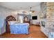 Spacious bedroom with decorative stone fireplace and hardwood flooring at 8880 W La Mancha Ave, Las Vegas, NV 89149