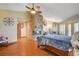 Main bedroom with a stone fireplace, hardwood floors, and French doors to the yard at 8880 W La Mancha Ave, Las Vegas, NV 89149
