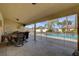 Spacious covered patio with dining area, views of the pool, and a seamless blend of indoor-outdoor living at 8880 W La Mancha Ave, Las Vegas, NV 89149