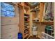 Bright walk-in closet with custom wooden shelving, drawers and organizational features at 8880 W La Mancha Ave, Las Vegas, NV 89149