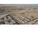 Expansive aerial view of community near highway, with views of surrounding desert landscape and mountains at 9050 W Tropicana Ave # 1178, Las Vegas, NV 89147