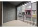 Balcony offering an urban view with a black metal railing and painted stucco walls at 9050 W Tropicana Ave # 1178, Las Vegas, NV 89147