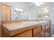 Bathroom vanity featuring double sinks, tile countertop, and wood cabinets at 9050 W Tropicana Ave # 1178, Las Vegas, NV 89147