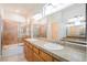 Bathroom featuring double sinks, a large mirror, and a shower-tub combo with a sliding glass door at 9050 W Tropicana Ave # 1178, Las Vegas, NV 89147