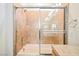 Close up of a shower-tub combo with a sliding glass door, showerhead, and tile surround at 9050 W Tropicana Ave # 1178, Las Vegas, NV 89147