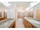 Bathroom featuring double sinks, large mirrors, and a shower-tub combo at 9050 W Tropicana Ave # 1178, Las Vegas, NV 89147