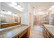 Bathroom with double sinks, large mirrors, and a shower-tub combo with sliding glass door at 9050 W Tropicana Ave # 1178, Las Vegas, NV 89147