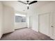 Bright bedroom featuring a ceiling fan, neutral carpet and large window at 9050 W Tropicana Ave # 1178, Las Vegas, NV 89147