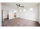 Spacious bedroom with neutral carpet, a ceiling fan, and an ensuite bathroom at 9050 W Tropicana Ave # 1178, Las Vegas, NV 89147