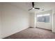 This bedroom features plush carpet, a ceiling fan, and a large window that provides great natural light at 9050 W Tropicana Ave # 1178, Las Vegas, NV 89147