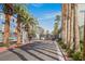 Gated community entrance with palm trees lining the road, providing a secure and inviting atmosphere at 9050 W Tropicana Ave # 1178, Las Vegas, NV 89147