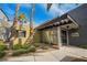Modern building entrance featuring glass doors, a covered entryway, and desert landscaping at 9050 W Tropicana Ave # 1178, Las Vegas, NV 89147