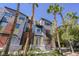 Unique multi-colored home with a modern exterior surrounded by lush landscaping and palm trees at 9050 W Tropicana Ave # 1178, Las Vegas, NV 89147