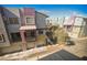 A street-level view of colorful townhomes featuring private garages, balconies, and modern architectural design at 9050 W Tropicana Ave # 1178, Las Vegas, NV 89147