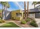 Building exterior with modern architectural features and desert landscaping with palm trees at 9050 W Tropicana Ave # 1178, Las Vegas, NV 89147