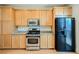 Kitchen showcasing modern appliances, light wood cabinets, and granite countertops for food prep at 9050 W Tropicana Ave # 1178, Las Vegas, NV 89147