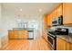 Open concept kitchen with granite countertops, wood cabinets, and stainless steel appliances at 9050 W Tropicana Ave # 1178, Las Vegas, NV 89147
