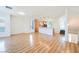 Spacious open-concept living area with hardwood floors, a kitchen, and access to the staircase at 9050 W Tropicana Ave # 1178, Las Vegas, NV 89147