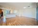 Open-concept living space with hardwood floors connecting the living area, kitchen, and staircase at 9050 W Tropicana Ave # 1178, Las Vegas, NV 89147