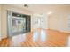 Bright living room with hardwood floors and a sliding door to a balcony with neighborhood views at 9050 W Tropicana Ave # 1178, Las Vegas, NV 89147