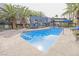 Relaxing community pool area featuring poolside seating, palm trees, and a modern clubhouse at 9050 W Tropicana Ave # 1178, Las Vegas, NV 89147