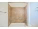 This bathroom shower features updated tilework, a modern shower head, and updated fixtures at 9050 W Tropicana Ave # 1178, Las Vegas, NV 89147