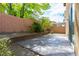 Backyard with a concrete patio, landscaping, and a block wall at 9445 Sweetwood Ave, Las Vegas, NV 89149