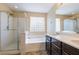 Bright bathroom with glass shower, soaking tub, dual sink vanity and lots of natural light at 9445 Sweetwood Ave, Las Vegas, NV 89149
