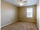 Neutral-colored bedroom featuring a ceiling fan and natural light from a window with blinds at 9445 Sweetwood Ave, Las Vegas, NV 89149